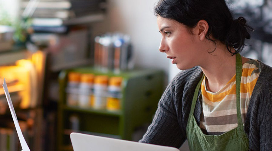 Woman working at her desk; image used for HSBC New Zealand GreedID page